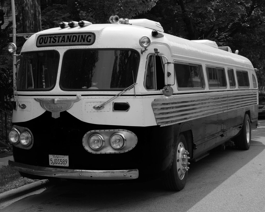 Vintage bus with California plates on Williamson Street, Madison, WI, July 29, 2025